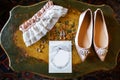 Wedding shoes on the vintage table, bridal garter and rings