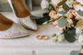 Wedding shoes and wedding paraphernalia, wedding bouquet, wedding gold rings Royalty Free Stock Photo