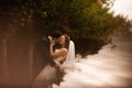 Wedding shot of bride and groom in park. Romantic scene in the park Royalty Free Stock Photo