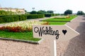 Wedding sign on wooden arrow in park Royalty Free Stock Photo