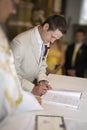 The wedding signature. Groom signing the register Royalty Free Stock Photo