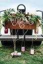 Wedding Signboard just married, on a golf carriage adorned with flowers and tin cans on the golf course