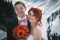 Wedding snowboarders couple just married at mountain winter