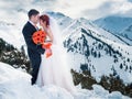 Wedding snowboarders couple just married at mountain winter