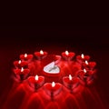 Wedding solitaire ring in heart shaped red box with heart shaped candle on red background. Valentine`s day concept. Royalty Free Stock Photo