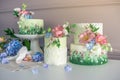 Wedding spring cake decorated with colorful flowers and hydrangeas. Desserts for a festive summer mood