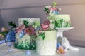 Wedding spring cake decorated with colorful flowers and hydrangeas. Desserts for a festive summer mood