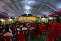 Wedding stage for jai mala prograamme with green carpet red chair and white coulor roof silver front,