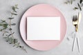 Wedding stationery invitation card mockup 7x5 on grey background with eucalyptus, Menu card mockup with table setting Royalty Free Stock Photo