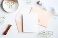 Wedding stationery on marble desk table. Blank wedding invitation card mockup, pastel pink envelopes, rings, wax seal stamp, Royalty Free Stock Photo