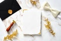 Wedding stationery set. RSVP card mockup, black envelope, wax stamp, golden branches, butterfly tie on marble table. Luxury,