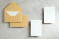 Wedding stationery template. Top view kraft paper envelopes and blank paper card on stone tabletop. Minimal style. Flat lay