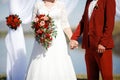 Wedding in style Marsala color. Bride and groom holding hands at altar. Royalty Free Stock Photo