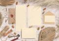 Wedding suite cards and envelope near dried plants, palm leaves and pampas grass Royalty Free Stock Photo