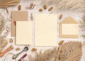 Wedding suite cards and envelopes near dried plants, palm leaves and pampas grass Royalty Free Stock Photo