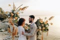 Wedding on the sunset with live floristry. Bride and groom in boho style. Royalty Free Stock Photo