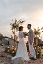 Wedding on the sunset with live floristry. Bride and groom in boho style. Royalty Free Stock Photo