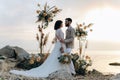 Wedding on the sunset with live floristry. Bride and groom in boho style. Royalty Free Stock Photo