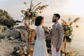 Wedding on the sunset with live floristry. Bride and groom in boho style. Royalty Free Stock Photo