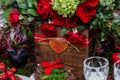 Wedding table decor: flowers composition with roses,berries, herbs and greenery standing in wooden box. Bridal details and decorat