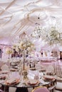 Wedding table decor in white green tones. Wedding table set up in boho style with pampas grass and greenery, soft focus Royalty Free Stock Photo