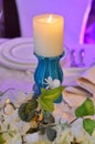 Wedding table decorated with flowers and big candle Royalty Free Stock Photo