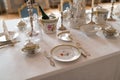 Wedding table decoration with expensive retro royal majesty porcelain service plates and cutlery in a palace