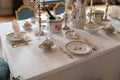 Wedding table decoration with expensive retro royal majesty porcelain service plates and cutlery in a palace