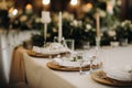 Wedding table decoration with flowers on the table, candlelit dinner table decor