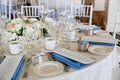 Wedding table decoration series - tables set for beautiful indoor catered luxury wedding event with blue napkins Royalty Free Stock Photo