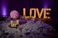 Wedding table dining set with Love light bulb sign decoration for wedding valentine day. Royalty Free Stock Photo