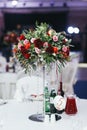 Wedding table with drinks decorated with bouquet of roses and gr