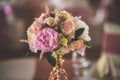 Wedding table with exclusive floral arrangement prepared for reception, wedding or event centerpiece in rose gold color Royalty Free Stock Photo