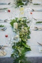 Wedding table with exclusive floral arrangement prepared for reception, wedding or event centerpiece in greenery style