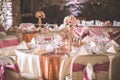 Wedding table with exclusive floral arrangement prepared for reception, wedding or event centerpiece in rose gold color Royalty Free Stock Photo