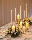 wedding table set for dining, white candles and flowers decorations on a wedding, wedding celebrations concept Royalty Free Stock Photo