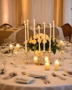 wedding table set for dining, white candles and flowers decorations on a wedding, wedding celebrations concept Royalty Free Stock Photo