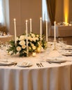 wedding table set for dining, white candles and flowers decorations on a wedding, wedding celebrations concept Royalty Free Stock Photo