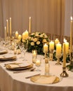 wedding table set for dining, white candles and flowers decorations on a wedding, wedding celebrations concept Royalty Free Stock Photo
