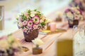 Wedding table setting. Beautiful table set with flowers and glass cups for some festive event, party or wedding reception Royalty Free Stock Photo