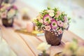 Wedding table setting. Beautiful table set with flowers and glass cups for some festive event, party or wedding reception Royalty Free Stock Photo