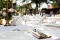 Wedding table setting decorated with fresh flowers in a brass vase. Wedding floristry. Banquet table for guests outdoors with a Royalty Free Stock Photo