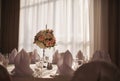 Wedding table setting decorated with fresh flowers in a vase. Royalty Free Stock Photo