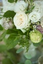 Wedding table setting is decorated with fresh flowers and white candles. Wedding floristry. Bouquet with roses, hydrangea and Royalty Free Stock Photo