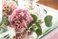 Wedding table setting is decorated with fresh flowers and white candles. Wedding floristry. Bouquet with roses, hydrangea and Royalty Free Stock Photo