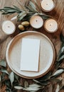 A wedding table setting featuring a card adorned with olive branches. Royalty Free Stock Photo