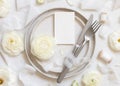 Wedding table setting with small card near cream roses and white silk ribbons top view, mockup