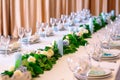 Wedding table settings. Empty plates and glasses on a white tablecloth. Royalty Free Stock Photo