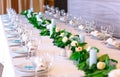 Wedding table settings. Empty plates and glasses on a white tablecloth. Royalty Free Stock Photo