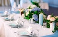 Wedding table settings. Empty plates and glasses on a white tablecloth. Royalty Free Stock Photo